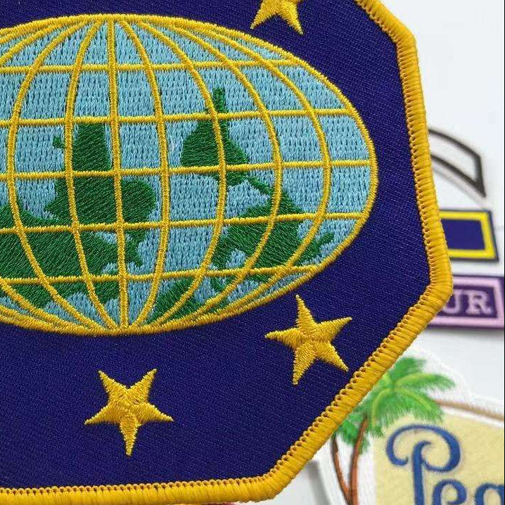 Close-up of an embroidered patch with a Merrow border